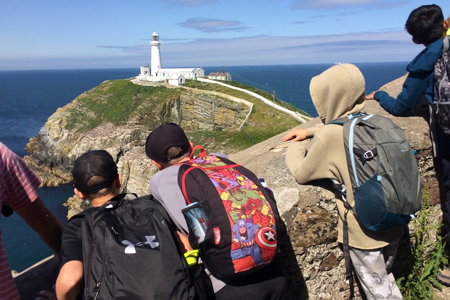 Pupils looking at a lighthouse in the distance