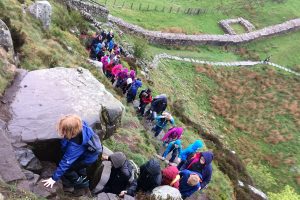 Children climbing a hill near Hadrian's Wall